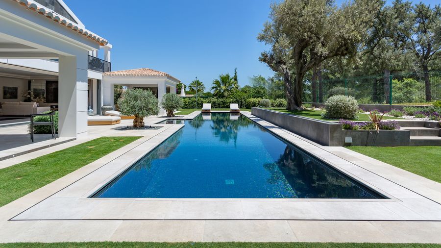 Long pool beside lawn and mature pines — Jacintina, Vale do Lobo